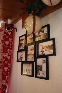 a group of pictures on a wall with a christmas ornament at Maison Sarteur Alloggio ad uso turistico -VDA-LA THUILE- 0065 in La Thuile