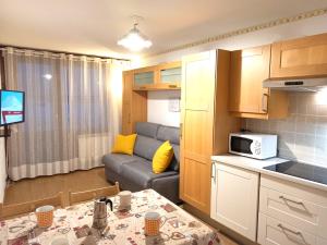 ブレウイル・チェルヴィナイアにあるFagus Cervinia apartment Vda Vacanze in Vetta CIR 0206の小さなリビングルーム(ソファ付)、キッチンが備わります。