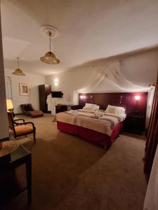 a large bedroom with a large bed and a couch at Apartmani Li in Livno