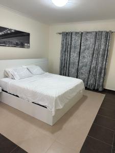 a bedroom with a white bed and a window at Furnished 2 Bedroom Apartment in Lavington Nairobi in Nairobi +45 photos