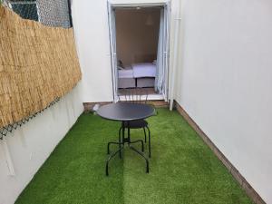 a small table in a small room with green grass at Nariken Apartments in Bristol