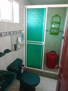 a bathroom with a shower and a toilet and a sink at Alojamiento Casa Luz Cielo in Puerto Colombia