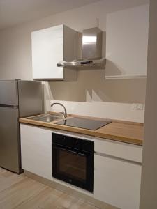 a kitchen with a sink and a refrigerator at La casetta - casa vacanze in Bisceglie