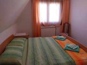 1 dormitorio con 1 cama con 2 toallas en Rent a house - "Laki" en Žabljak
