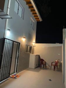 a room with two red chairs and a refrigerator at Departamento Noa in Villa Gesell