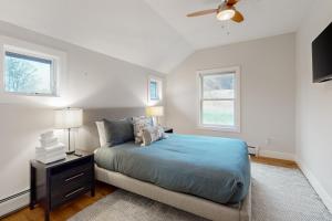 - une chambre avec un lit bleu et 2 fenêtres dans l'établissement Mountain View, à Stowe