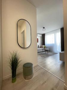 a living room with a mirror on the wall at SkyNest B404 in Bratislava