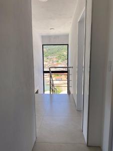 an empty hallway with a large window in a house at Casa Vista Mar in Governador Celso Ramos