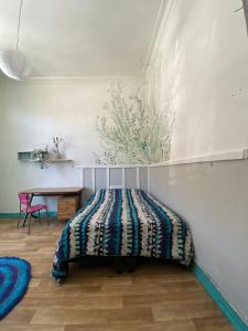 Un dormitorio con una cama y una mesa. en Hostel Don Poncho, en Valparaíso