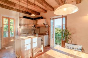 a kitchen with a table and a large window at Castellino Bella Vista in Ponte Tresa