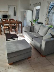 a living room with a couch and a table at Necochea-Casa para hasta 4 personas! in Necochea