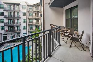 a balcony with a table and chairs next to a building at Perfect Getaway Rentals LLC in Tampa