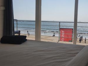 a bedroom with a bed and a view of a beach at Palolem Beach View Inn in Palolem