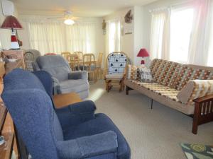 a living room with couches and chairs and a table at Oceanfront Duplex, 3 Bedrooms, 1 12 Baths in Brant Beach