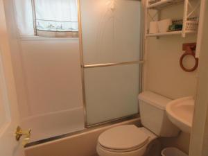 a small bathroom with a toilet and a shower at Oceanfront Duplex, 3 Bedrooms, 1 12 Baths in Brant Beach