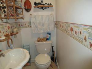 a small bathroom with a toilet and a sink at Oceanfront Duplex, 3 Bedrooms, 1 12 Baths in Brant Beach
