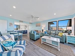 a living room with a couch and a table at 2 Bedroom 2 Bath 3Rd Floor Fishery Condo With Fabulous Ocean Views in Ship Bottom