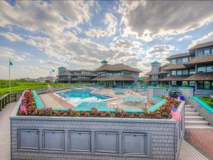 a large swimming pool in front of a resort at 2 Bedroom 2 Bath 3Rd Floor Fishery Condo With Fabulous Ocean Views in Ship Bottom