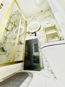 a bathroom with a sink and a white marble wall at Ensuite Luxury Bedroom In Purfleet in Purfleet