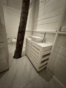 a bathroom with a sink and a palm tree at Palolem Beach View Inn in Palolem