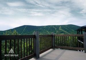 a view of the mountains from the porch of a house at Villa Mont Chocolat in Saint-Philémon