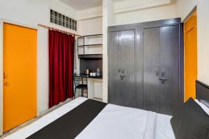 a bedroom with a bed and a red curtain at Flagship Aryan Home Stay in Dehradun