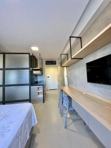 a kitchen with a long table and chairs in a room at Studio Moderno Westfit in Mossoró