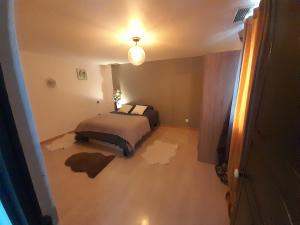a bedroom with a bed in a room with a floor reconstruction at Vacances entre plage et montagnes in Baigts-de-Béarn