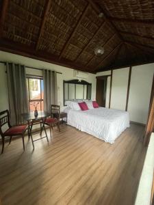1 dormitorio con 1 cama, mesa y sillas en Cinque Terre Pousada & Bistrô en Río de Janeiro
