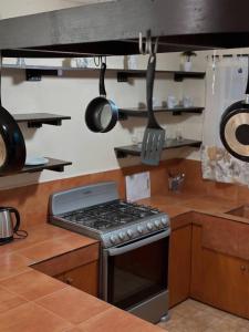 a kitchen with a stove and pots and pans at La Casita de Jonas in Puerto Morelos