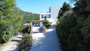 a white house on a hill with a road at Fabulous Villa in Monemvasia
