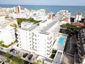 an aerial view of a large white building near the ocean at Palm beach appartment 80 mt dal mare e comodo per Venezia in Lido di Jesolo