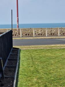 a fence on the side of a road near the ocean at Seabreeze The Annexe in Blackpool