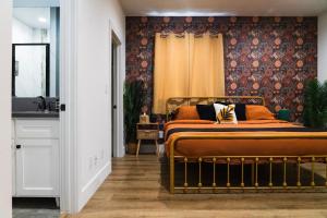 a bedroom with a bed with a orange bedspread at The Relyn in Inglewood