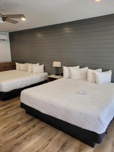 sypialnia z 2 łóżkami i białymi poduszkami w obiekcie Devon Shores w mieście Clearwater Beach