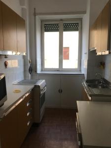 a small kitchen with a window and a sink at Villa Fiorelli rooms in Rome