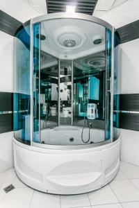 a bath tub with a shower in a room at Vip Apartment Zanzibar in Baku