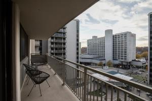 a balcony with chairs and a view of a city at Convenient Airport Proximity: Apt in Crystal City in Arlington