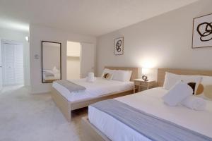 a hotel room with two beds and a mirror at Convenient Airport Proximity: Apt in Crystal City in Arlington