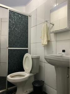 a bathroom with a toilet and a sink at Pousada Cactus in Barreirinhas
