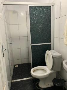 a bathroom with a toilet and a shower at Pousada Cactus in Barreirinhas