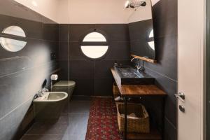 a bathroom with a sink and a tub and a toilet at B&B Design in Bologna +56 photos