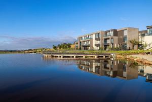 a building next to a body of water at Re’em Yarra Valley in Gruyere