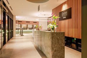 a lobby with a reception counter with flowers on it at Re’em Yarra Valley in Gruyere