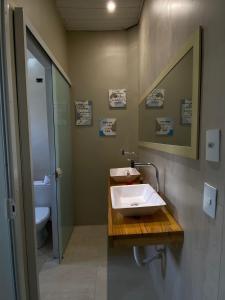 a bathroom with a sink and a toilet at Gup Hostel in Curitiba