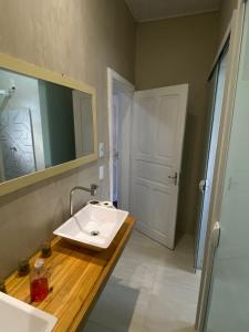 a bathroom with a white sink and a mirror at Gup Hostel in Curitiba