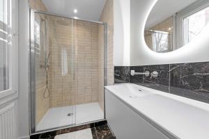 a bathroom with a shower and a sink and a mirror at Le Sapphire in Toulouse