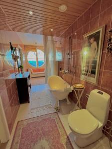 a bathroom with a tub and a toilet and a sink at Garden City Apartment, Helsinki - Vantaa Airport in Vantaa