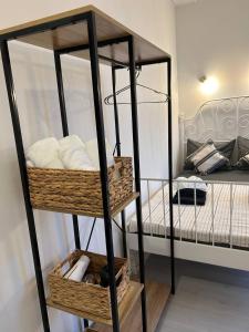 a room with a bunk bed and a black shelf with towels at Pirostka Vintage Room in Sofia