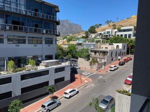 an aerial view of a city with cars parked on a street at The Quarter Mountain View Haven at Waterkant in Cape Town